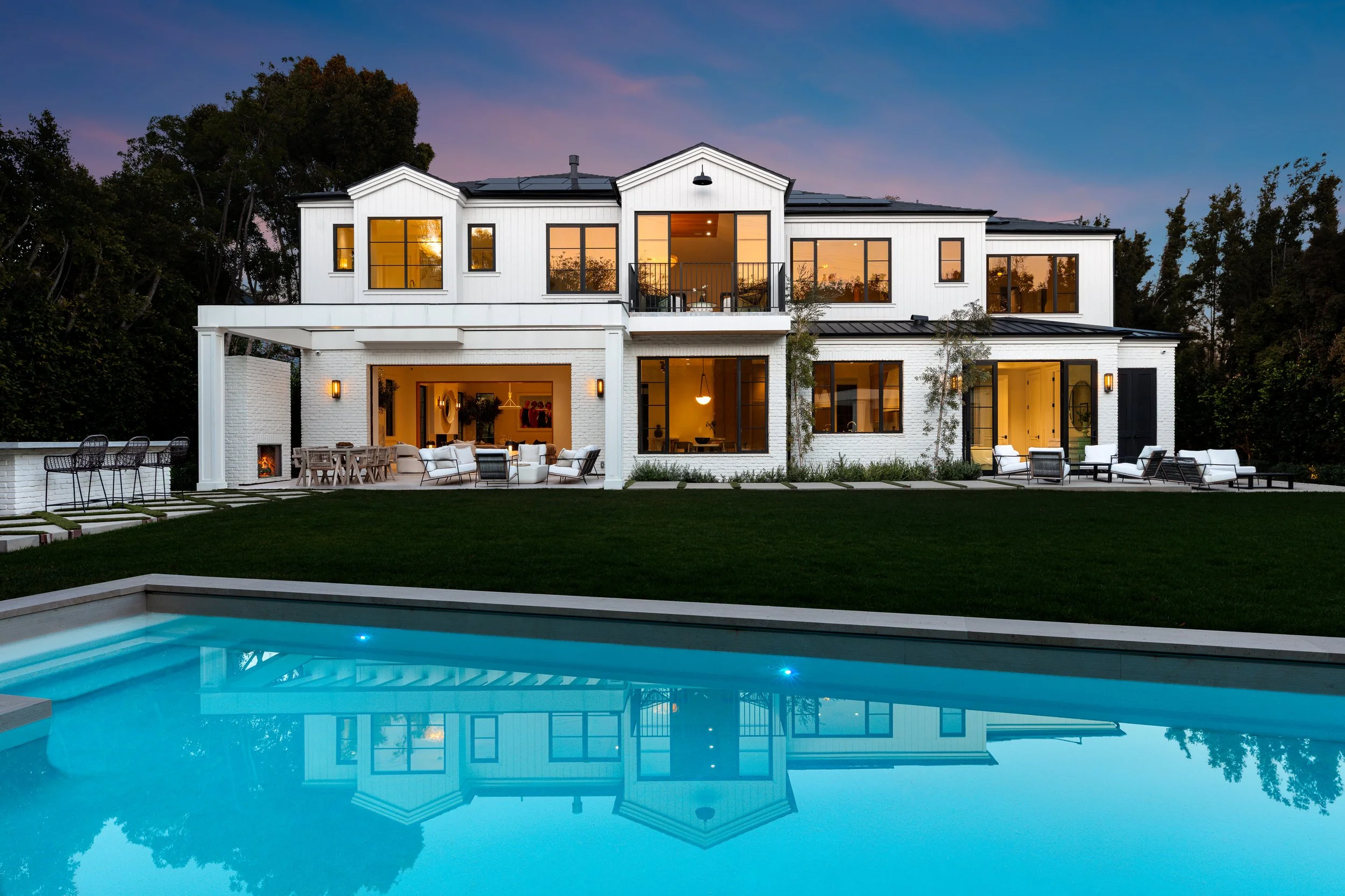 A twilight image showcasing the exterior of a luxury Beverly Hills home.