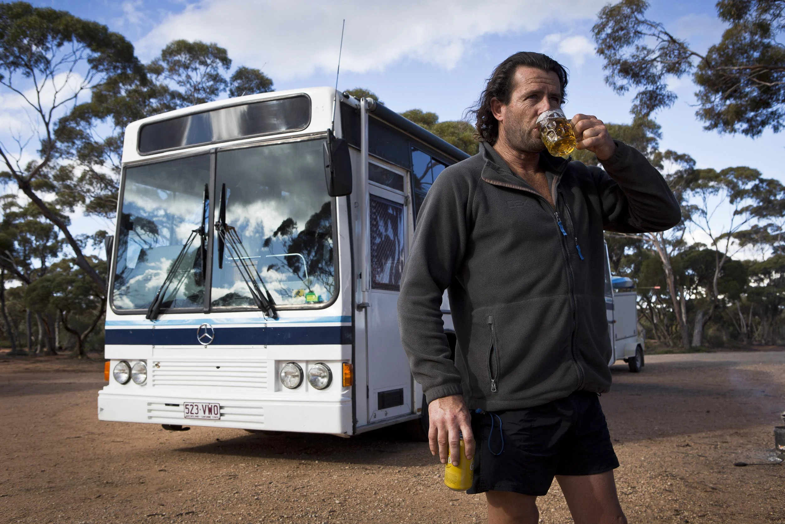 Jason McIntosh and his bus named "the Strawberry Cow", Balladonia, Western Australia.