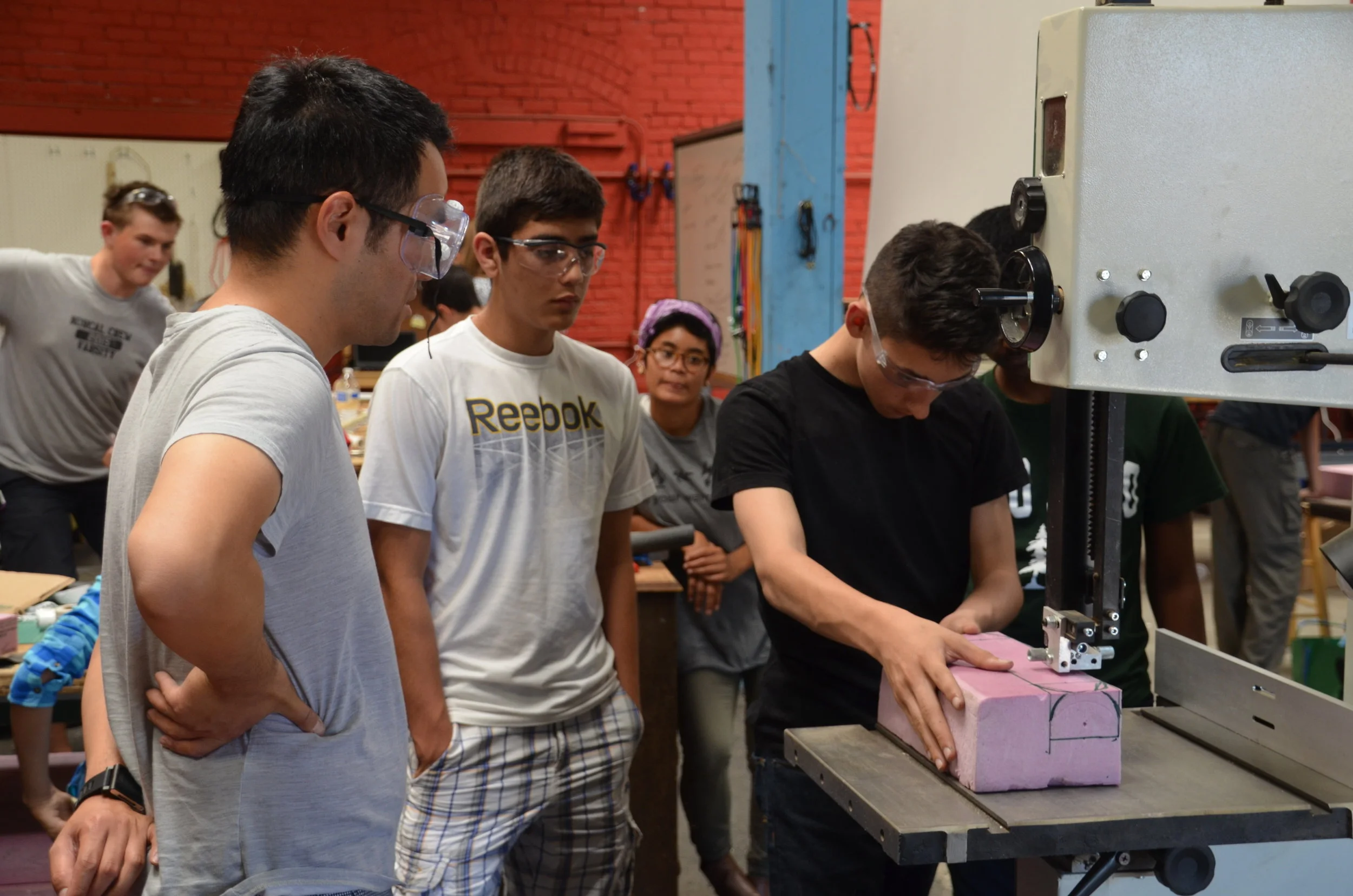 Students watching another student perform class tasks