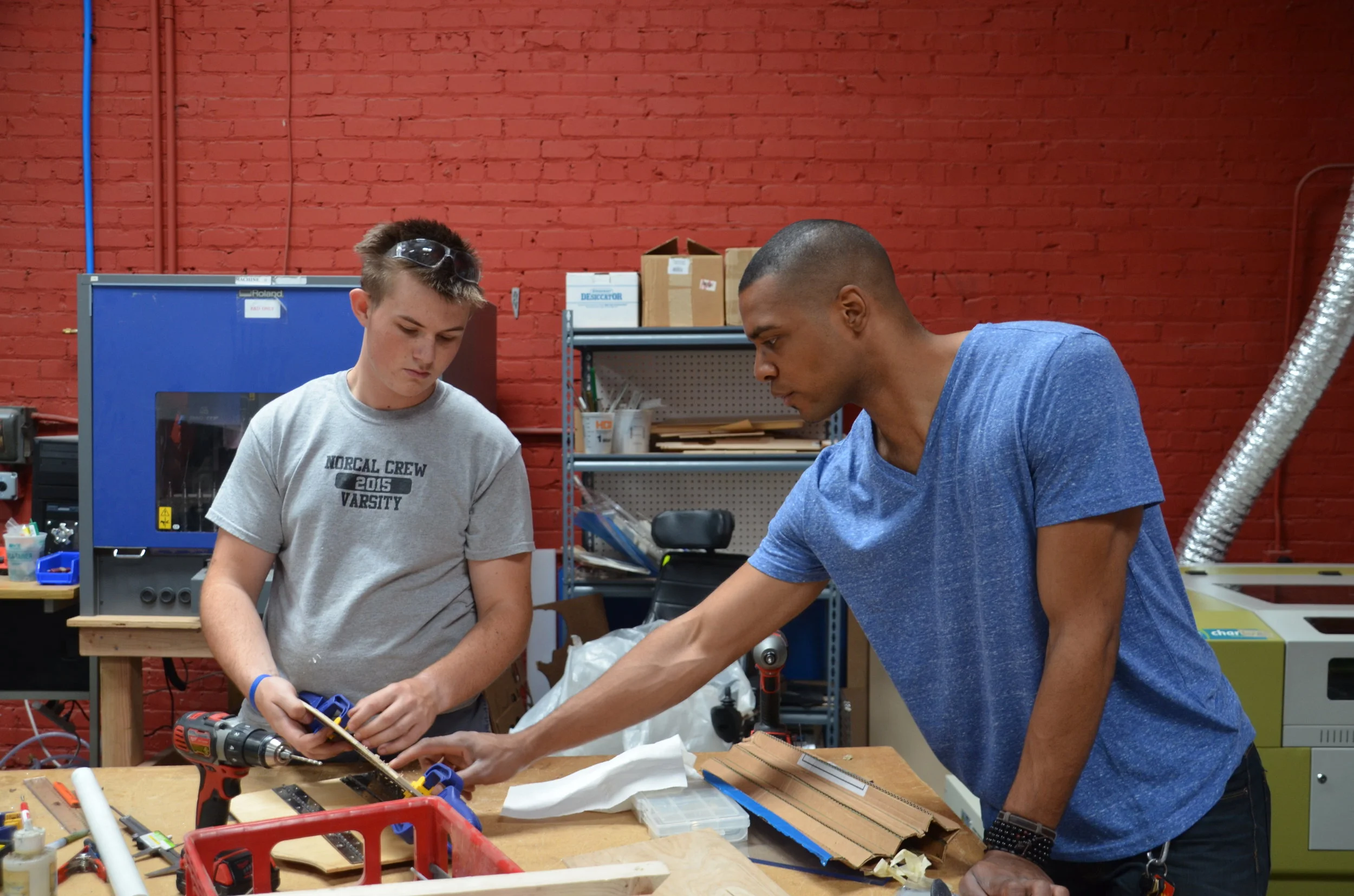 Instructor working with student on project