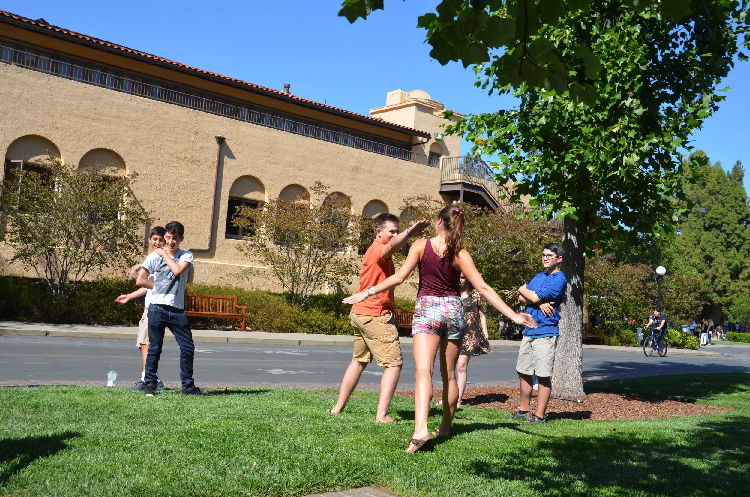 Group of students playing outside of campus