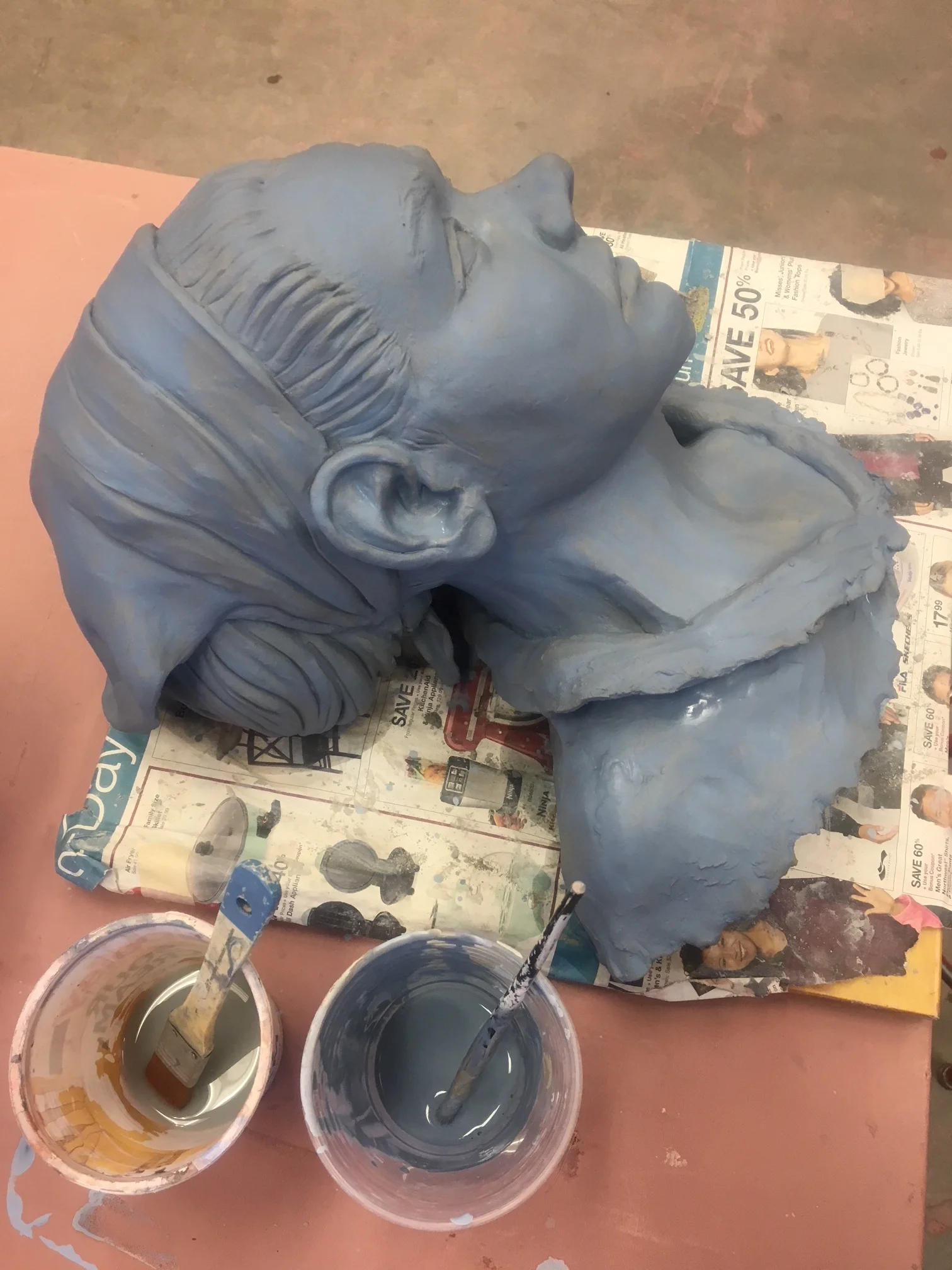 Adding blue slip to surface.