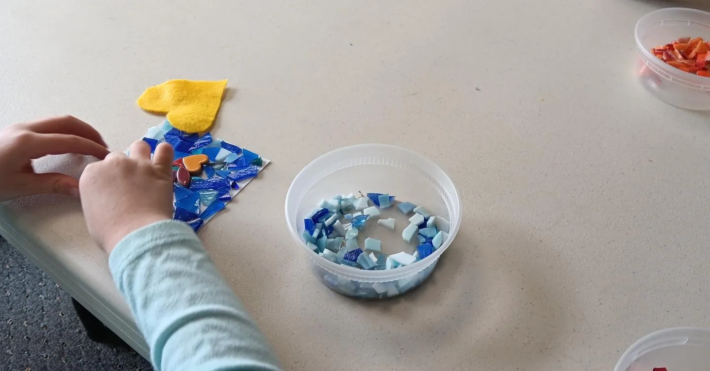 It was so fun to get our mural started this morning with little hands carefully arranging colorful pieces of ceramic and glass.  Storytime kiddos made 16 tiles- only 96 more to go!  Drop-in to the library this Saturday, April 18th, between 10:30 and 