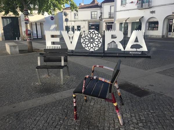 Urban knitting ornates individual seats in the old town of Evora, Portugal