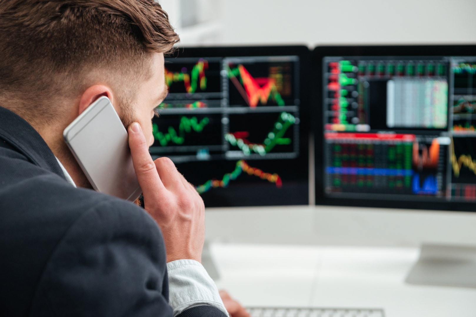 graphicstock-back-view-of-businessman-working-and-talking-on-mobile-phone-in-office_rId-Idmd2g.jpg