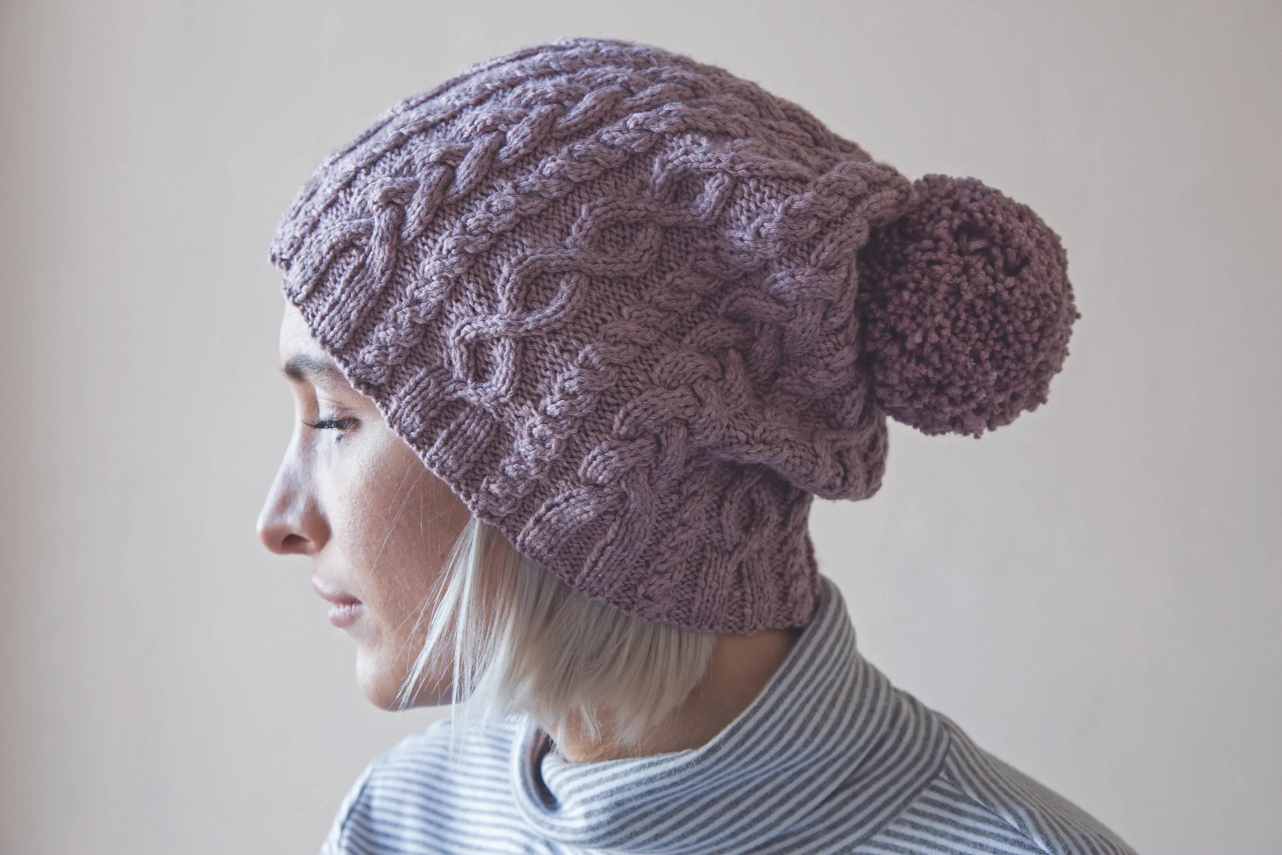 Harriet modelling the “hers” version of the His and Hers Hats in Easy Aran Knits .