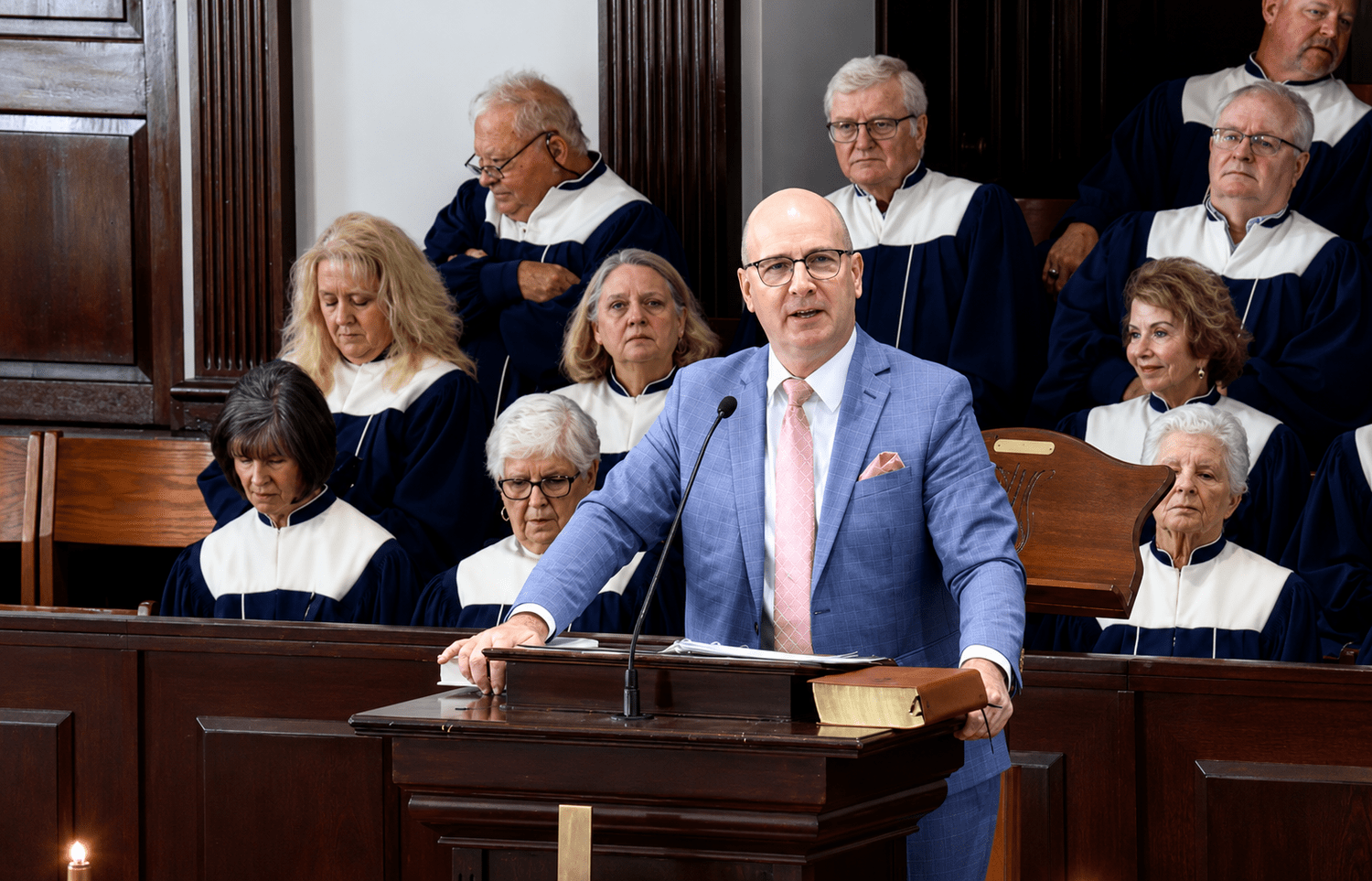Alan Sledge leading from the pulpit with the choir behind him