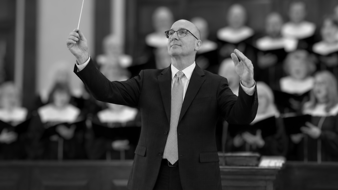 First Baptist choir director leading worship