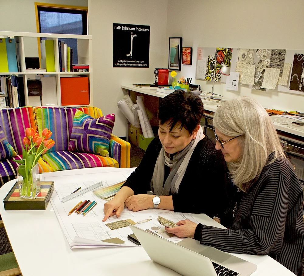 Working in the studio. The Technicolor-striped loveseat is one of my favorite estate sale finds!