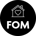 a black circle with the outline of a house with a heart inside the house in white