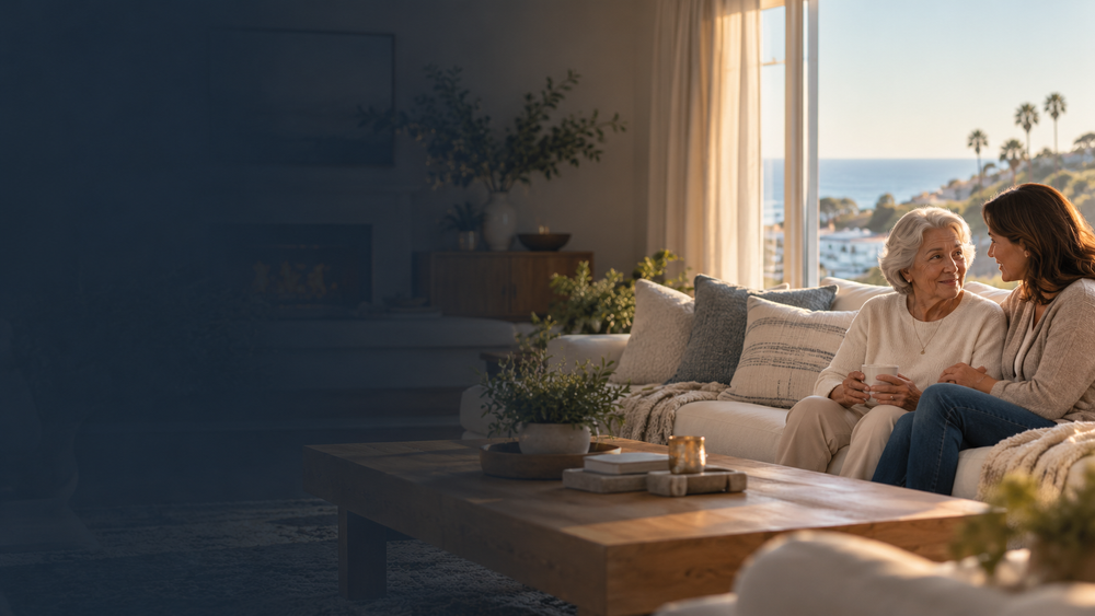 An older woman sharing a quiet moment with a companion in a familiar living room