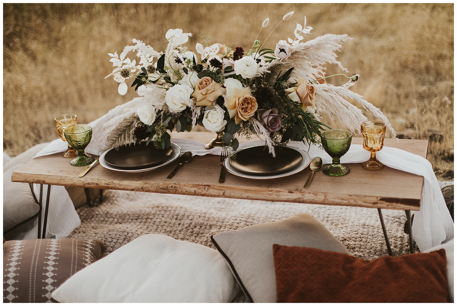  a small table set for two and adorned with a beautiful, dried bouquet 