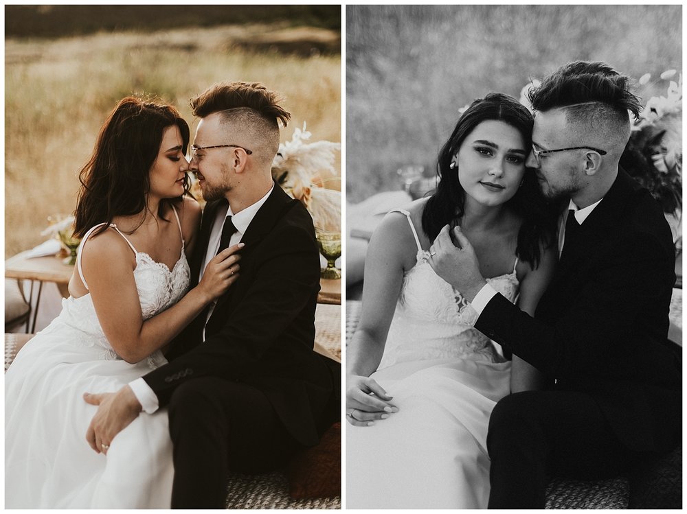 a bride and groom sit on the ground and snuggle up to one another