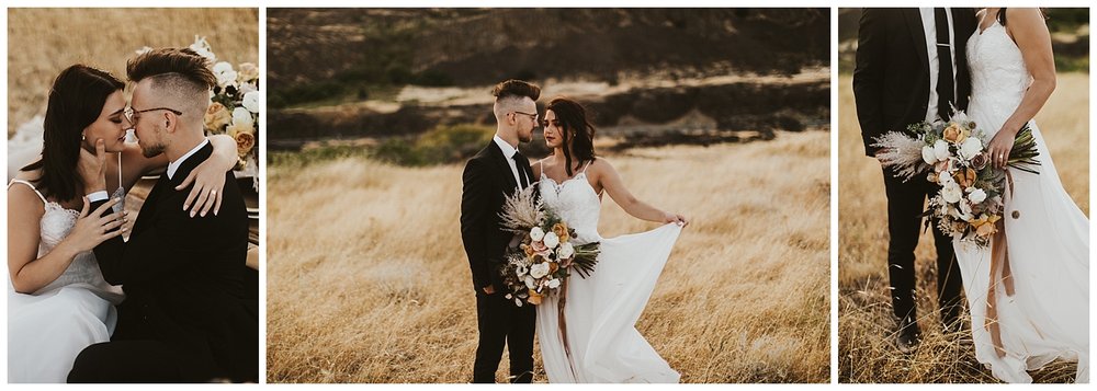 bride and groom cuddle up to one another in the desert while the sun sets