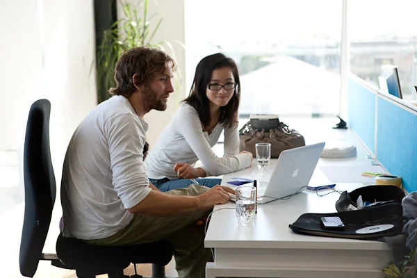 People collaborating at a communal workstation