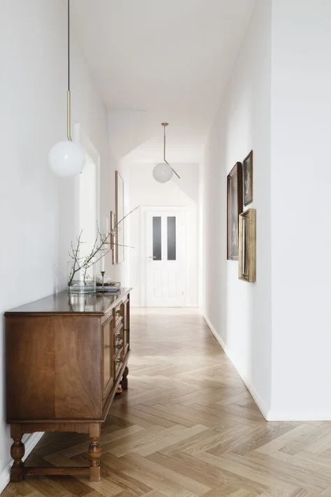I think this is a great example of using the one colour technique - this long, narrow hallway feels large and bright by using all one shade of white. The colour makes the hallway appear much more spacious than what it really is by blurring lines.