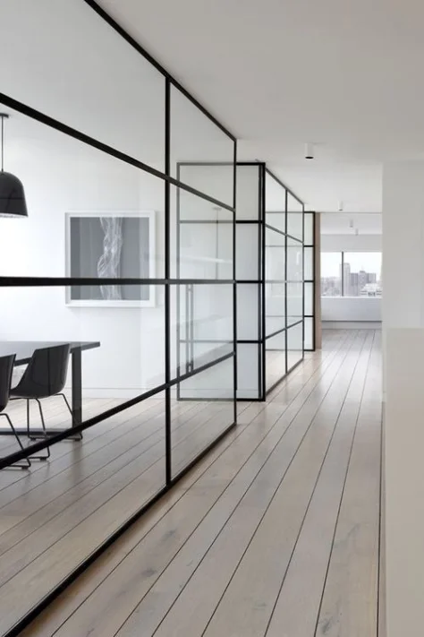 This small office encompasses the one colour in open plan idea perfectly. Paired with clear partition walls, this narrow hall way and meeting rooms look extremely spacious and bright. Had they of been broken into different colour zones there is no way this expansive appearence would have been achieved.