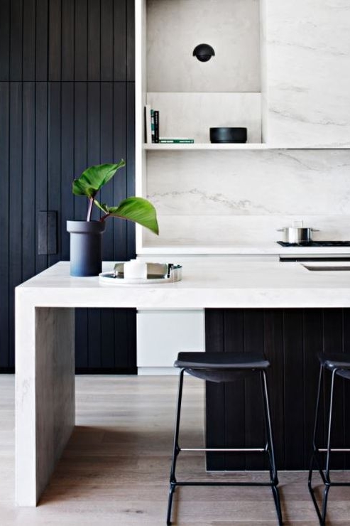 A bold Black and White look with chunky bench tops, softened with natural marble pattern. The 'see through' island end provides a moment of light relief from an other wise heavy space. 