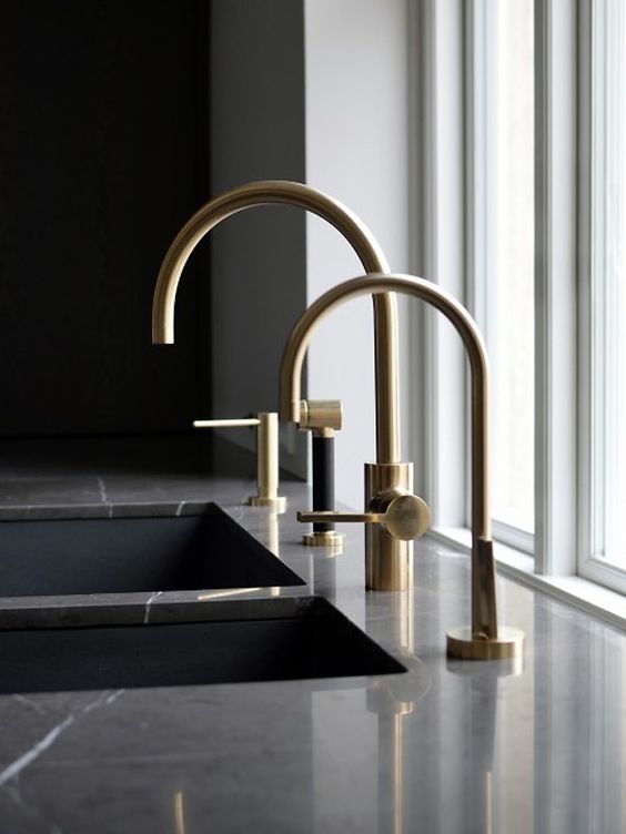 These brass taps are a beautiful design, against the black marble they make for a real statement.