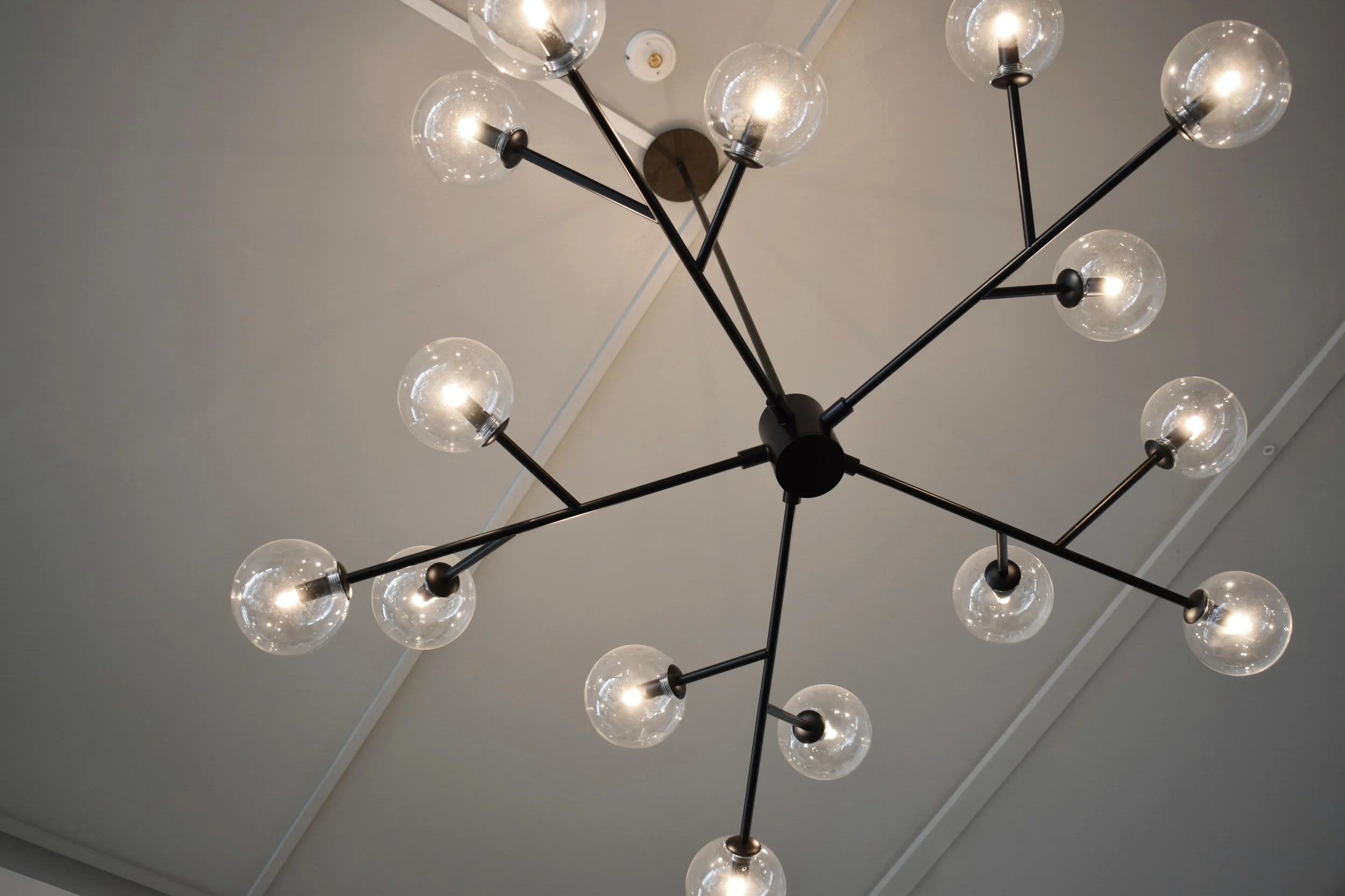 We painted the ceiling in the communal lounge area grey to make the lighting pop and define the space.