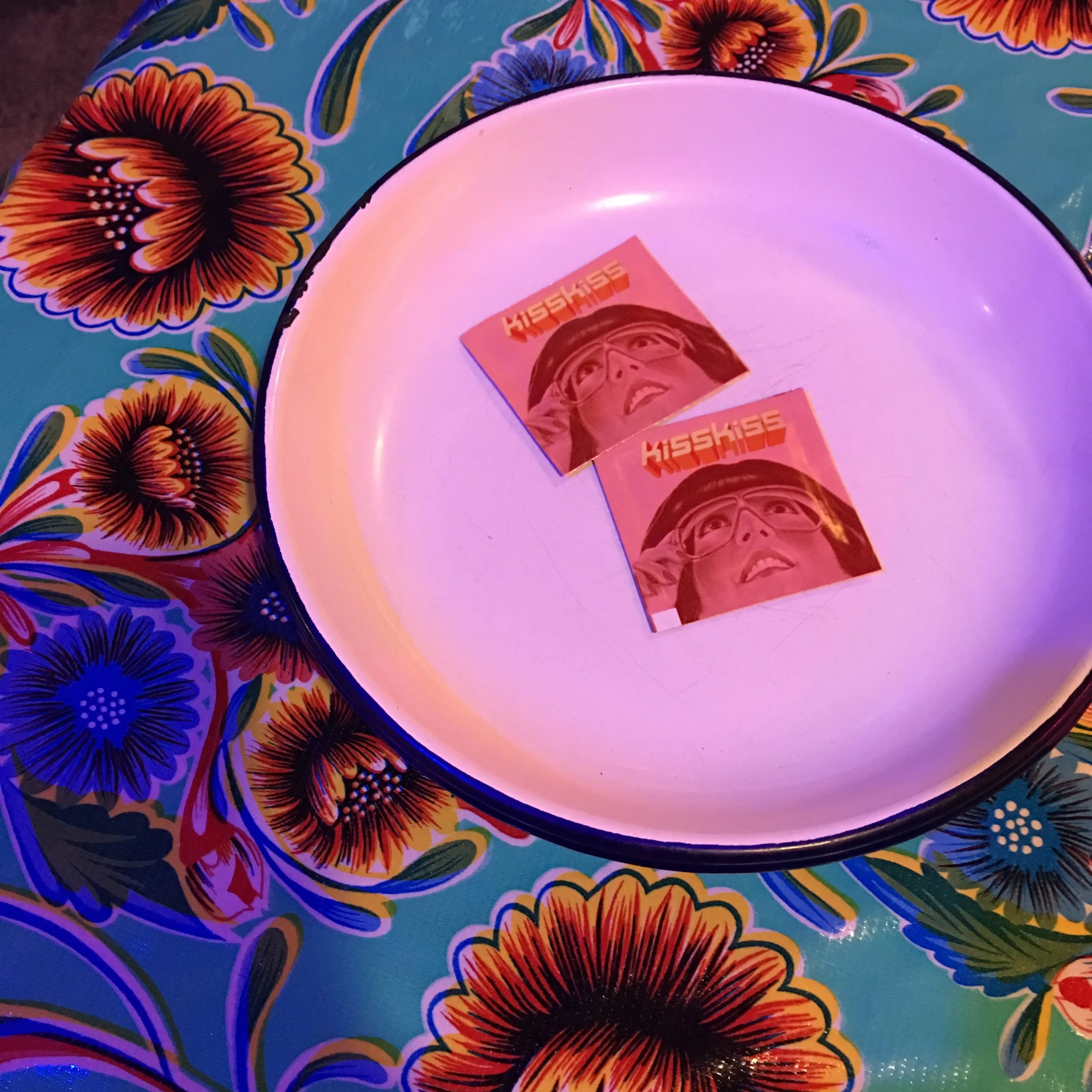 Kiss Kiss hand towelettes on enamel plate.