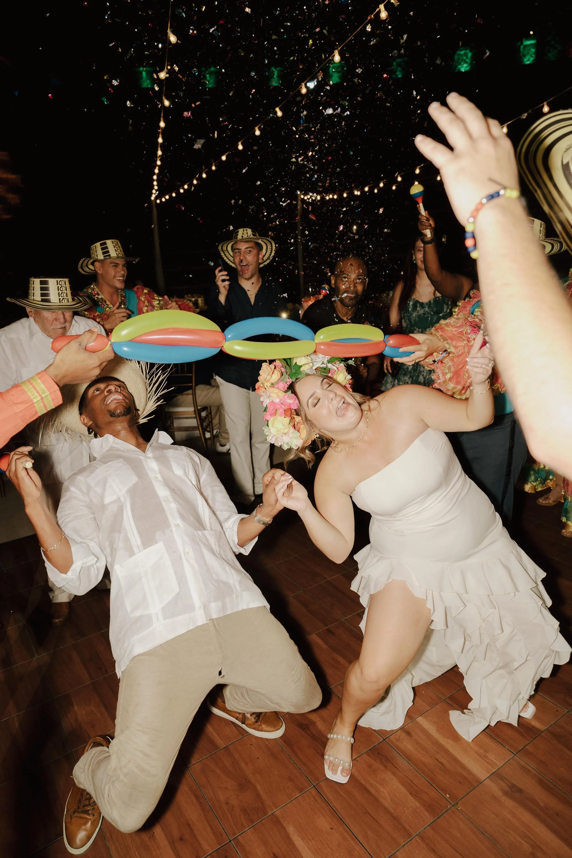 Bride and gromm partying in hora loca while confetti gets on them