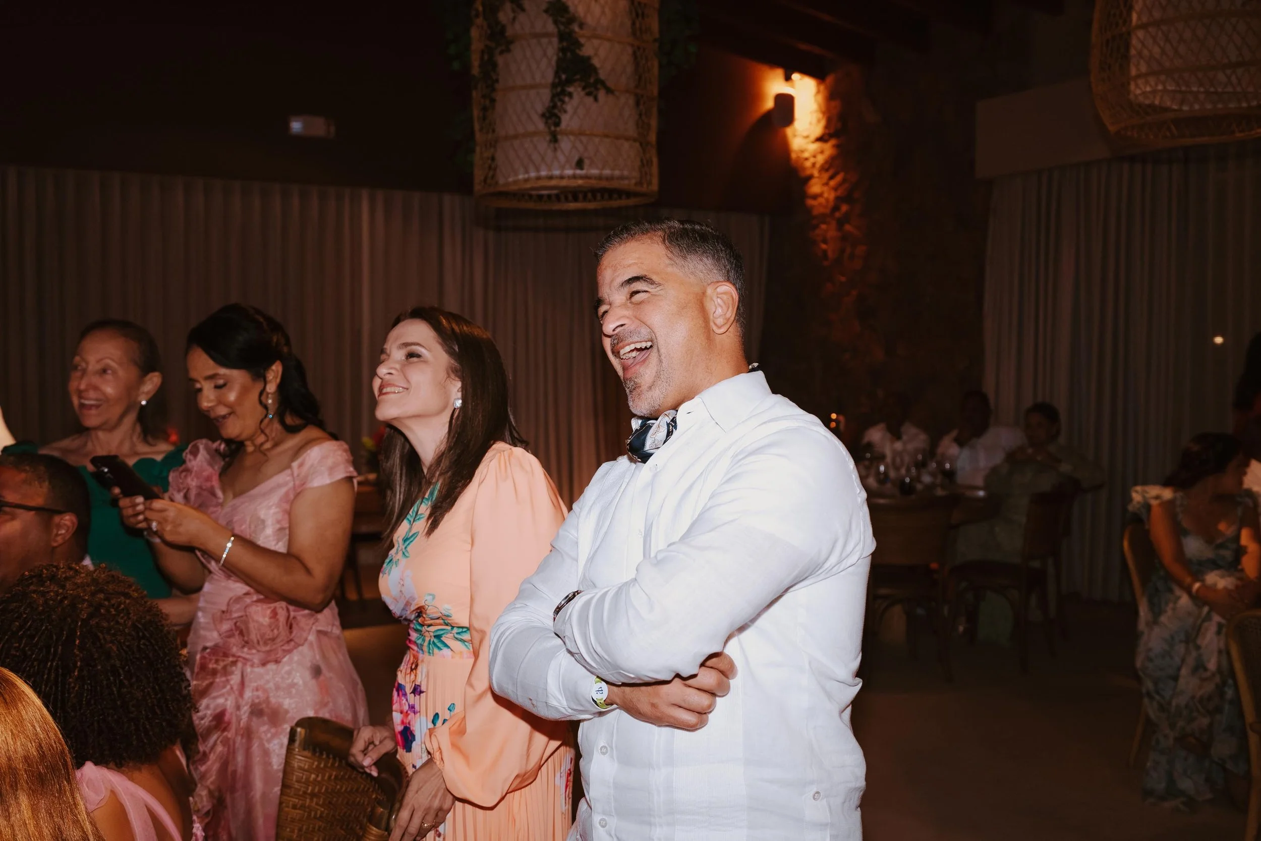 Candid and energetic wedding reception party in Punta Cana, with guests dancing and celebrating under warm lights