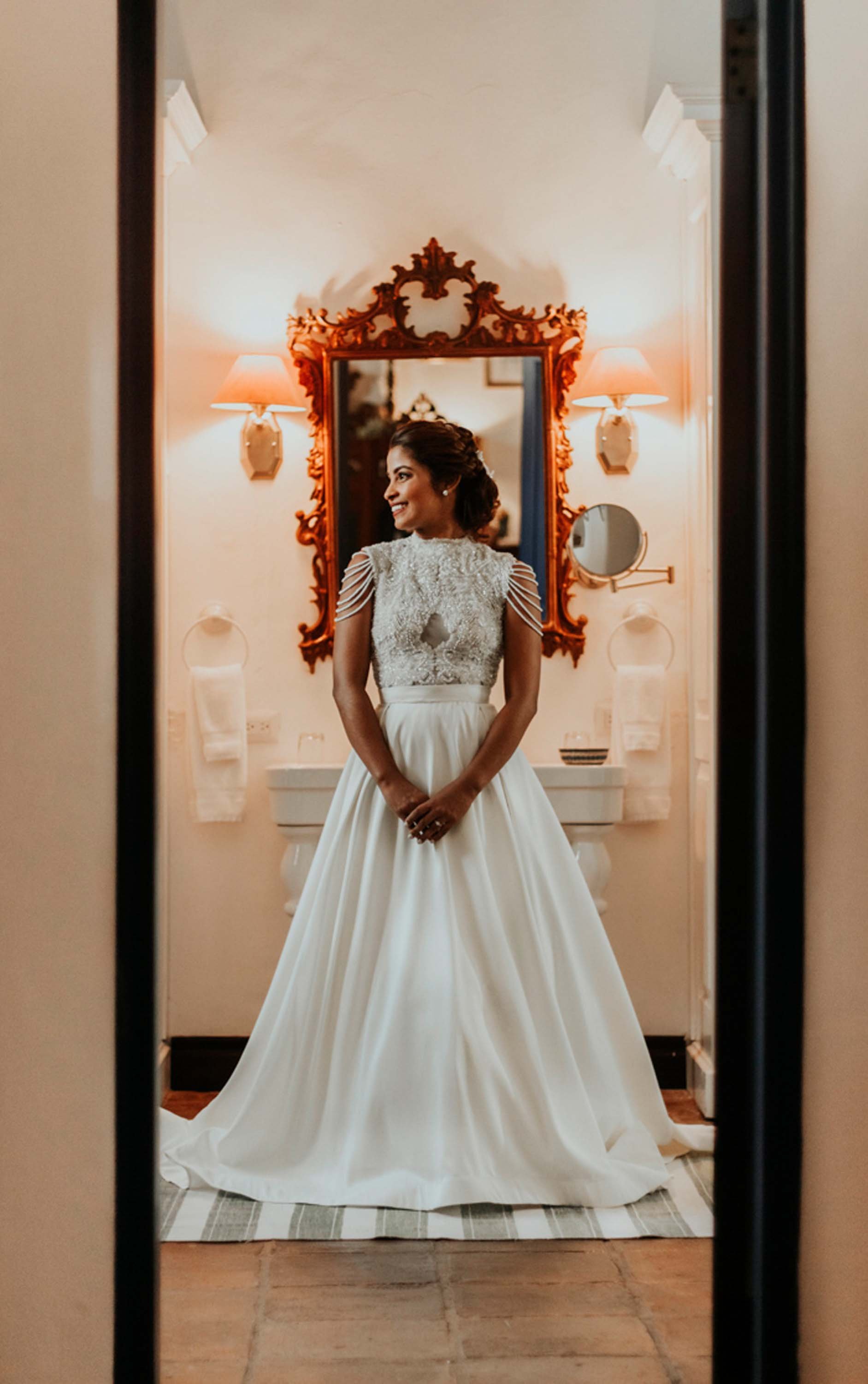 bride looking towars a window while posing for her portraits at casa del xvi in santo domingo