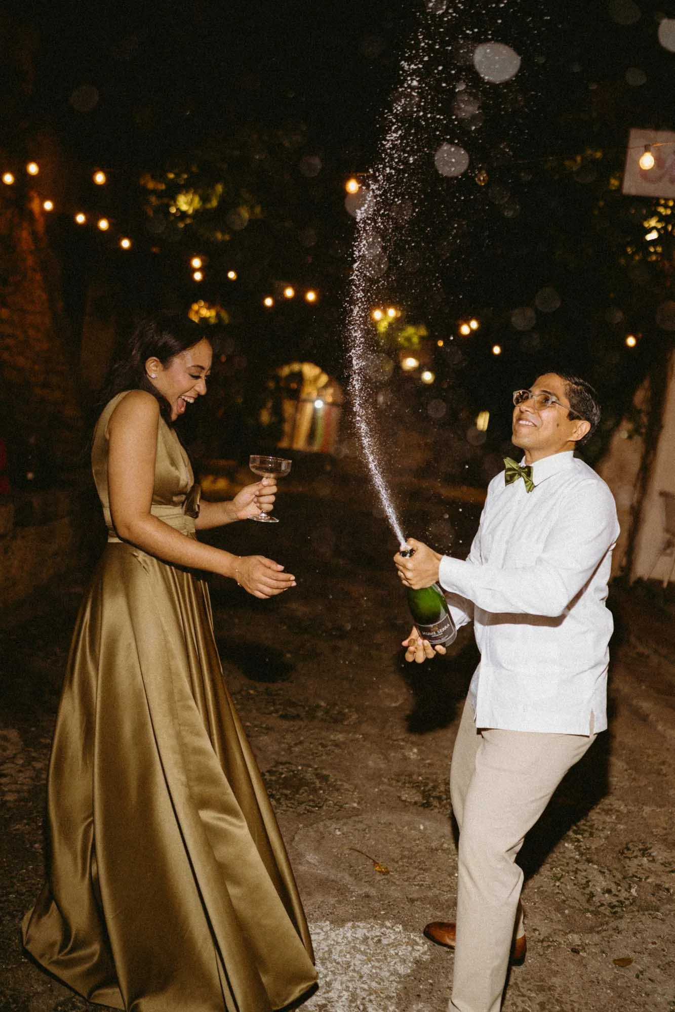 Night wedding photography with direct flash, champagne pop celebration in Dominican Republic.