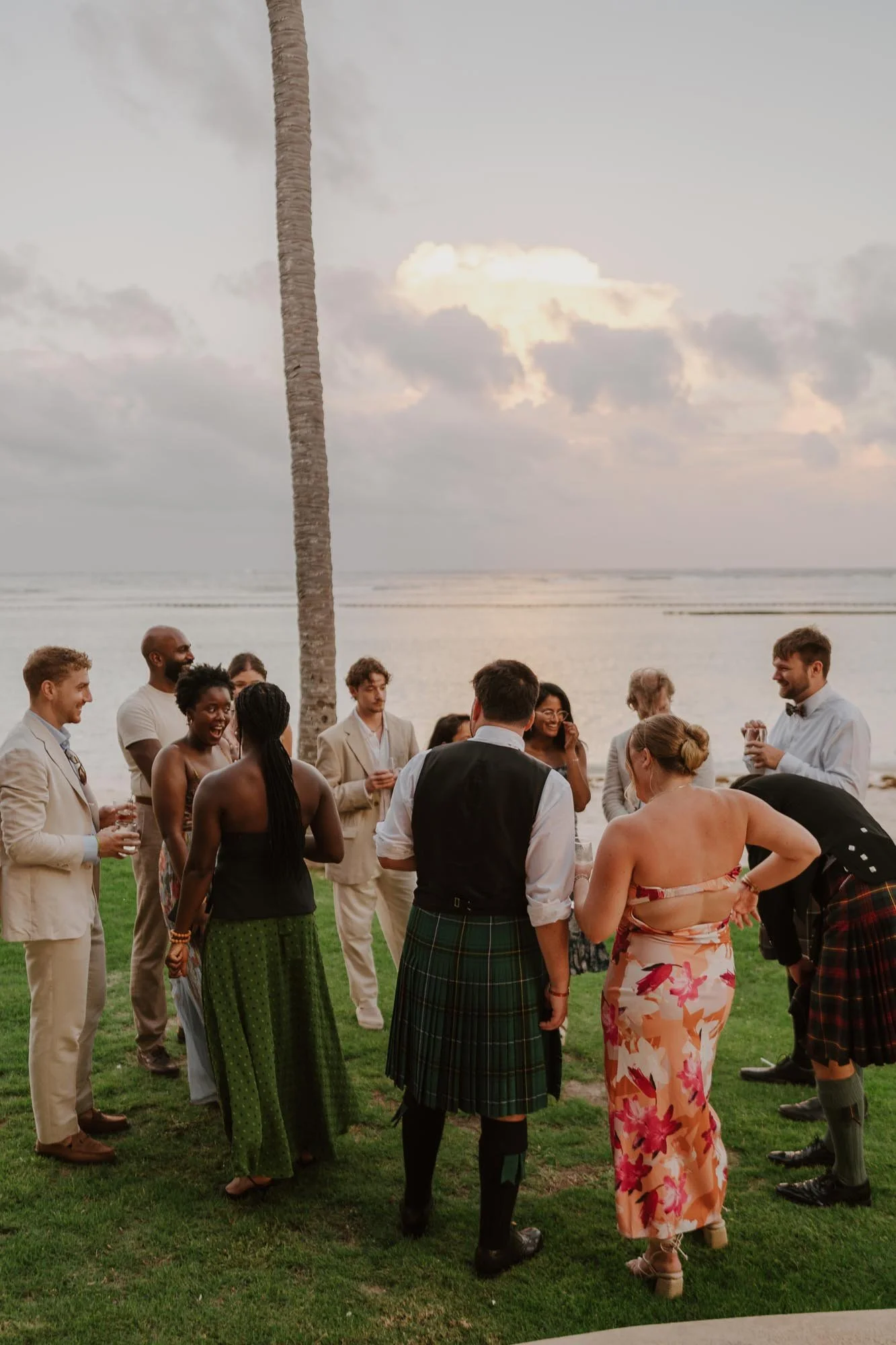 Guests enjoying a wedding with sunset in the background