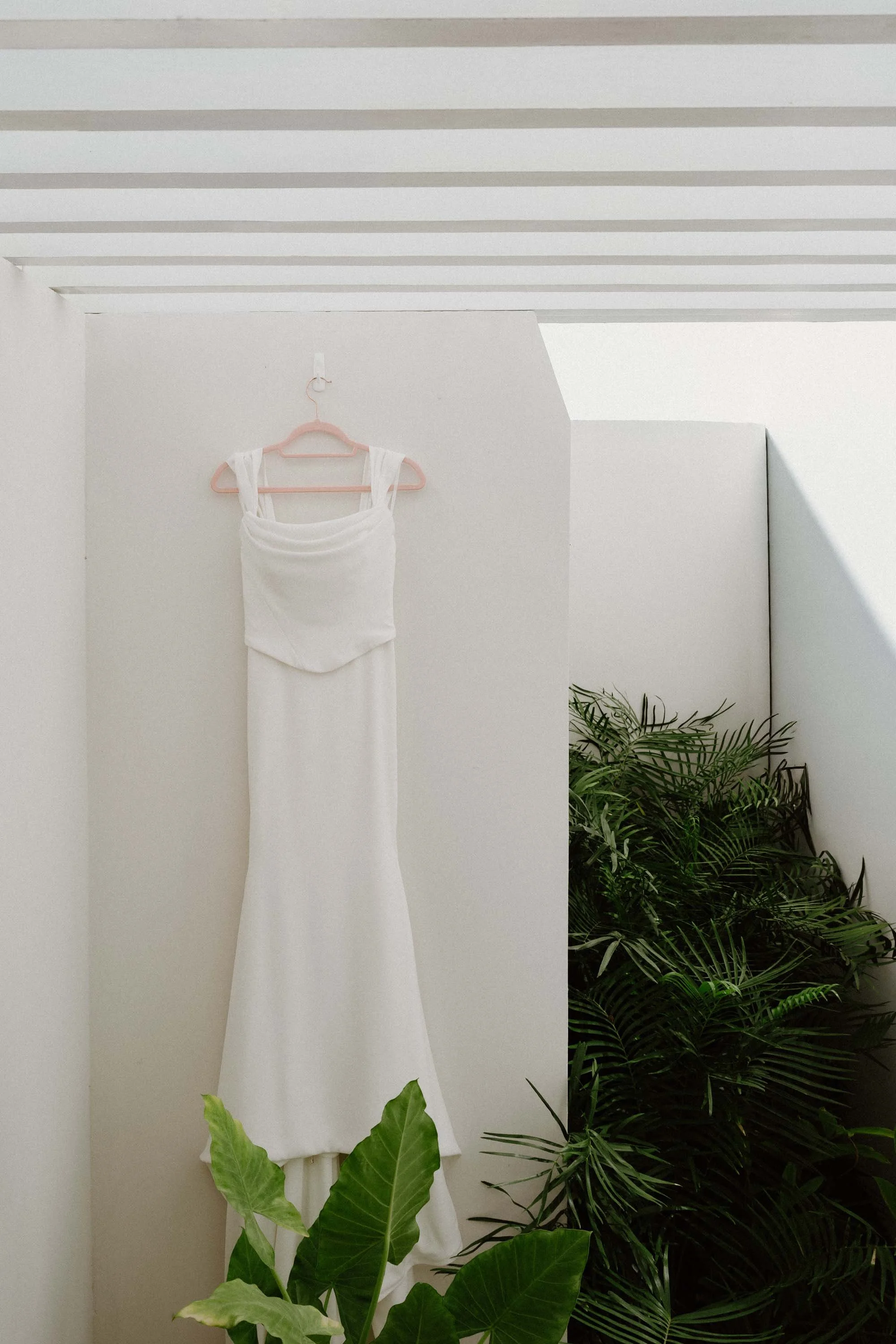 Bride wedding dress hagging up in a bridal suite