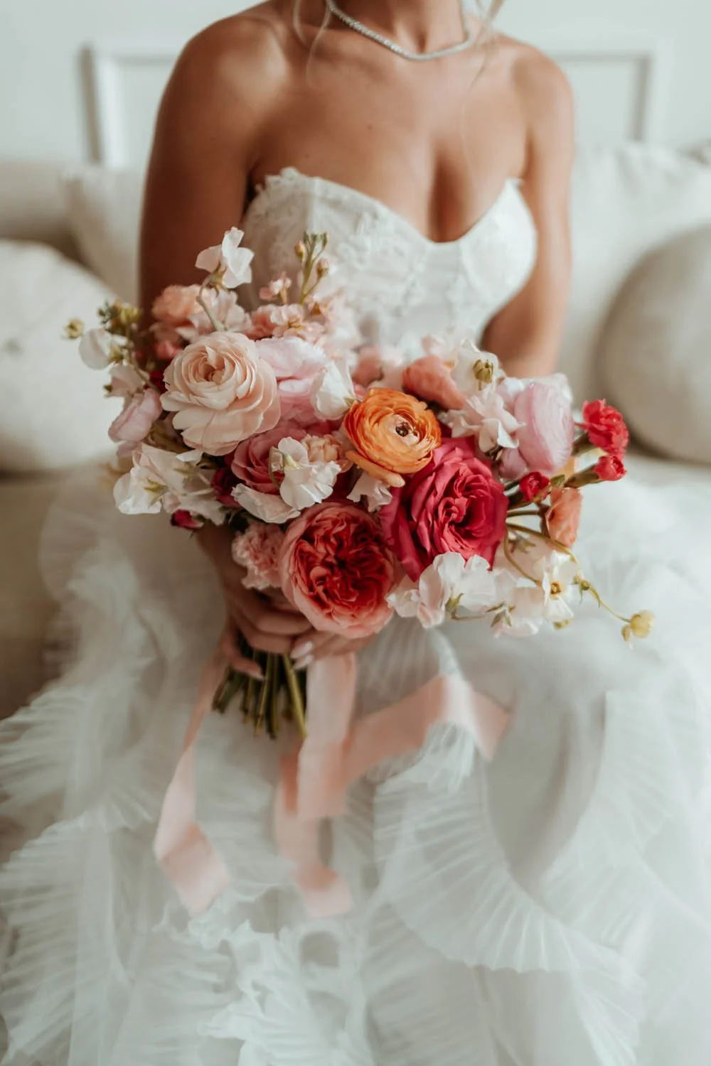 detail photo of bride holding colorfull bouquet