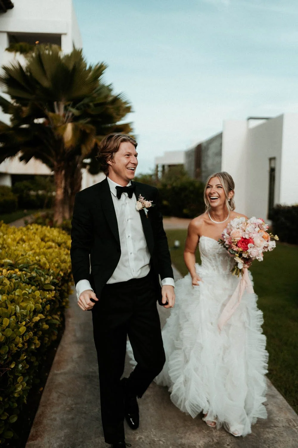 bride and groom walking down to their wedding ceremony after the first look