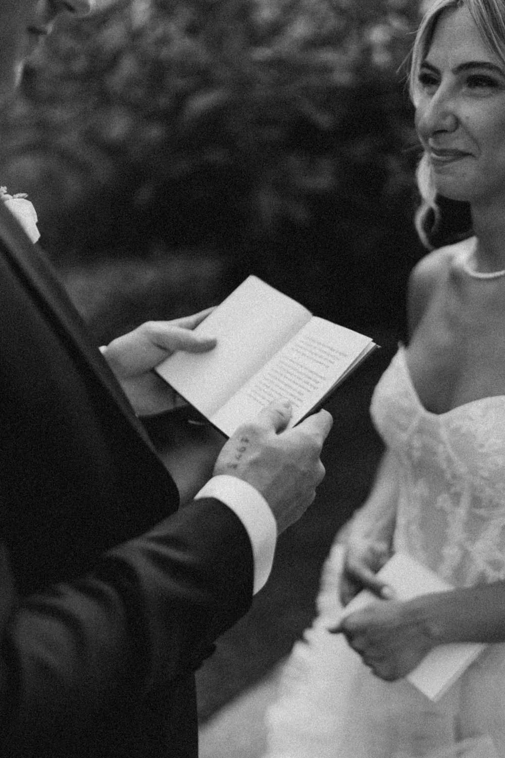 detail photo of the groom reading his vows