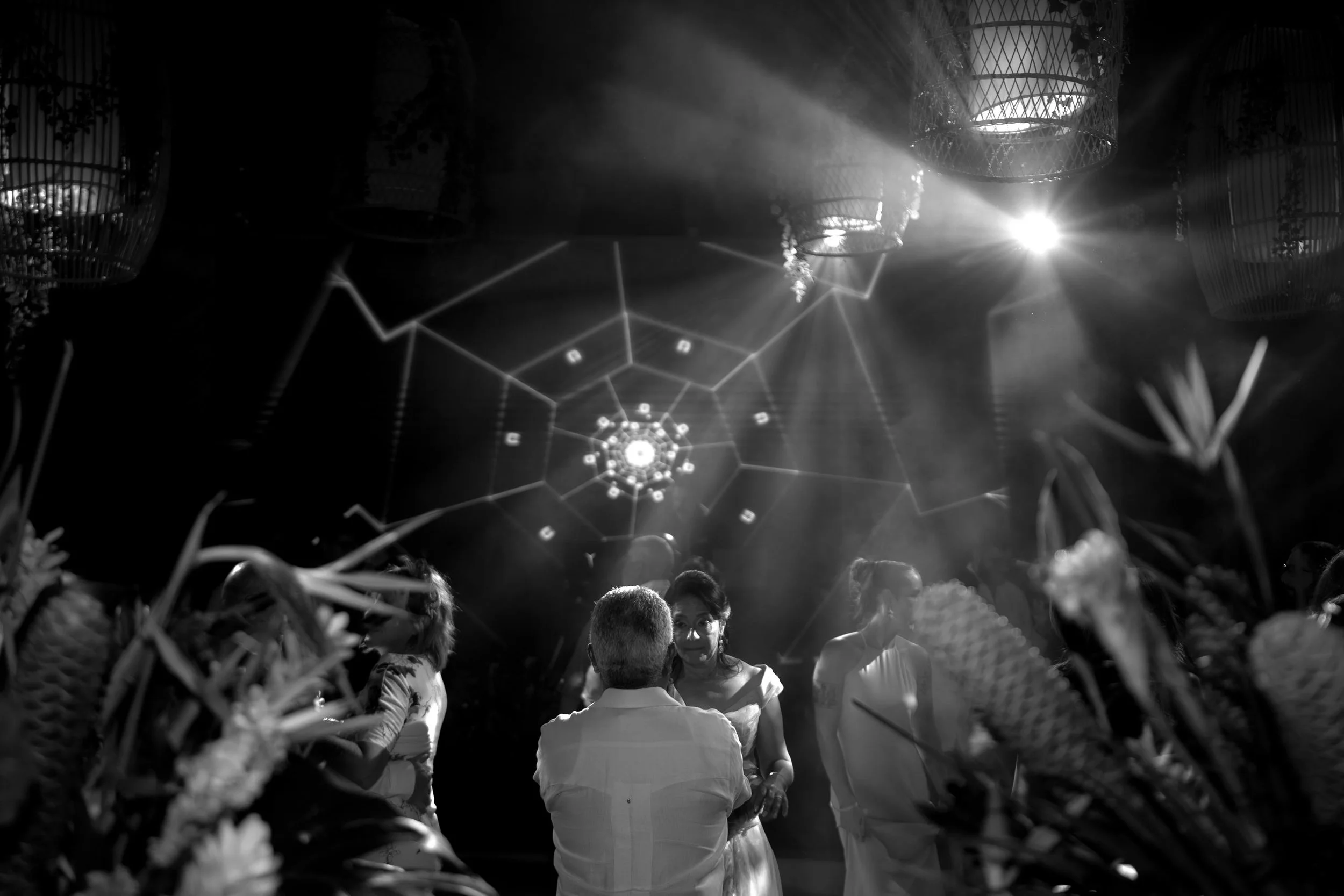 Candid and energetic wedding reception party in Punta Cana, with guests dancing and celebrating under warm lights