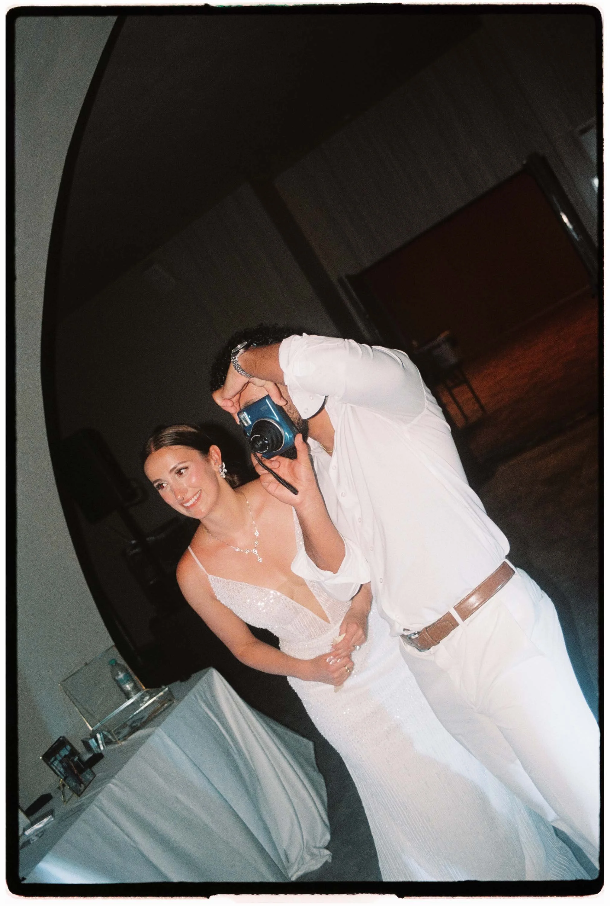 35mm film photo of the couple taking photos with a Instax mini camera