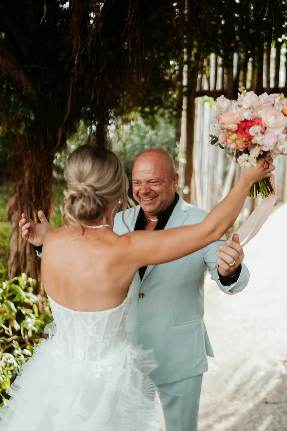 Father of the bride huging her during the first look
