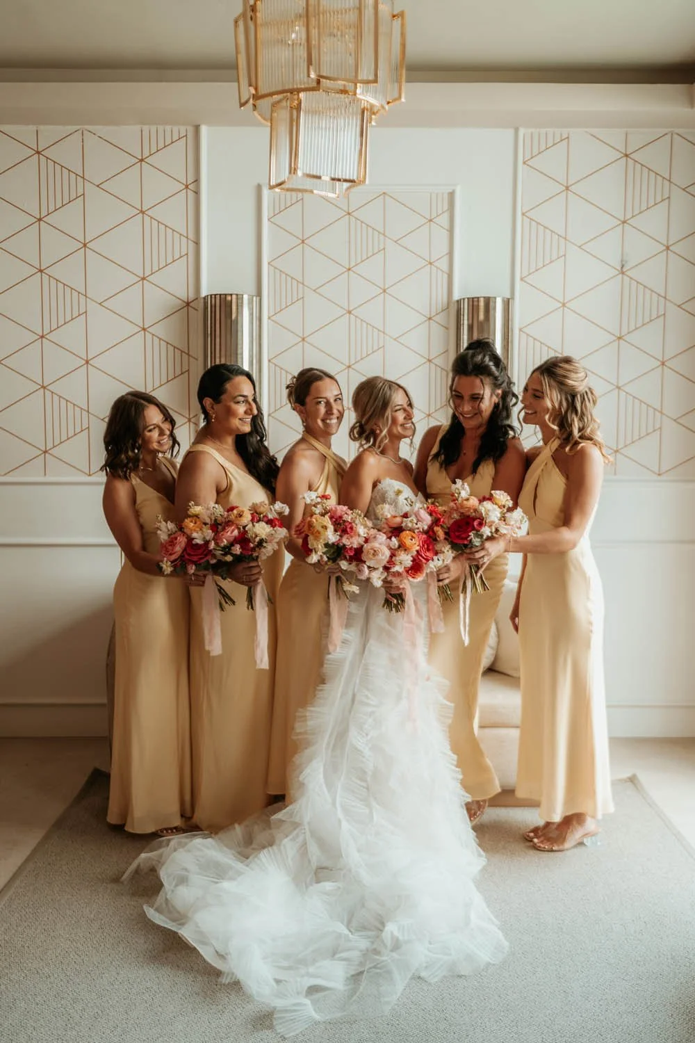 Bride looking to their bridemaids and being happy in the getting ready