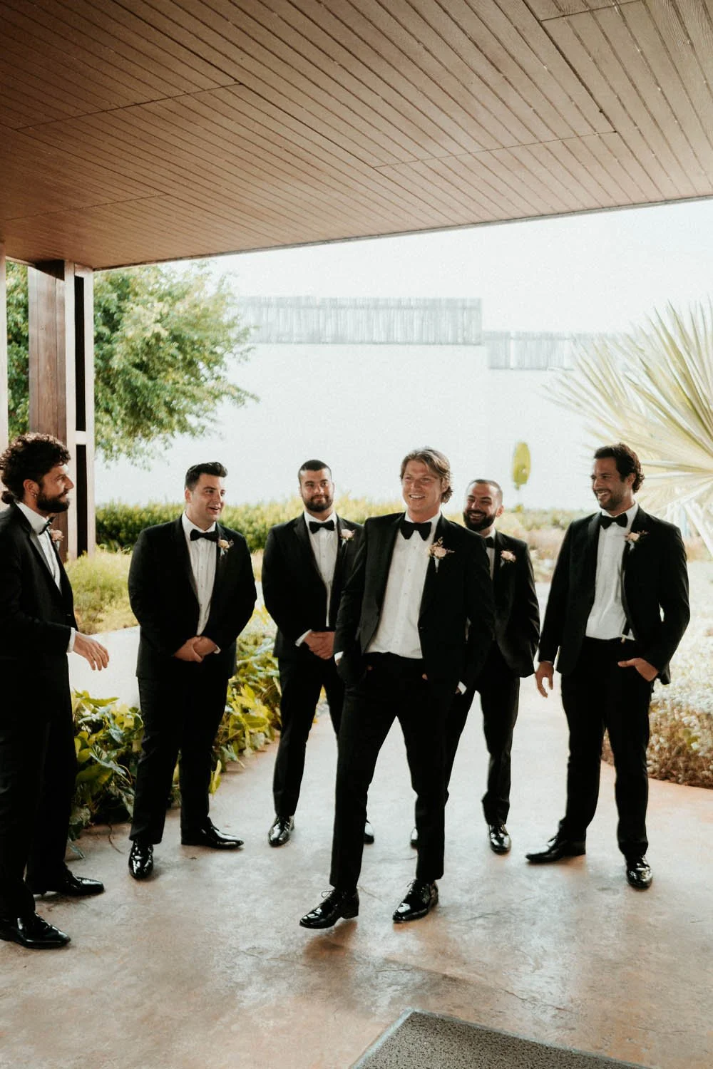 Bestmen and the groom looking eachother