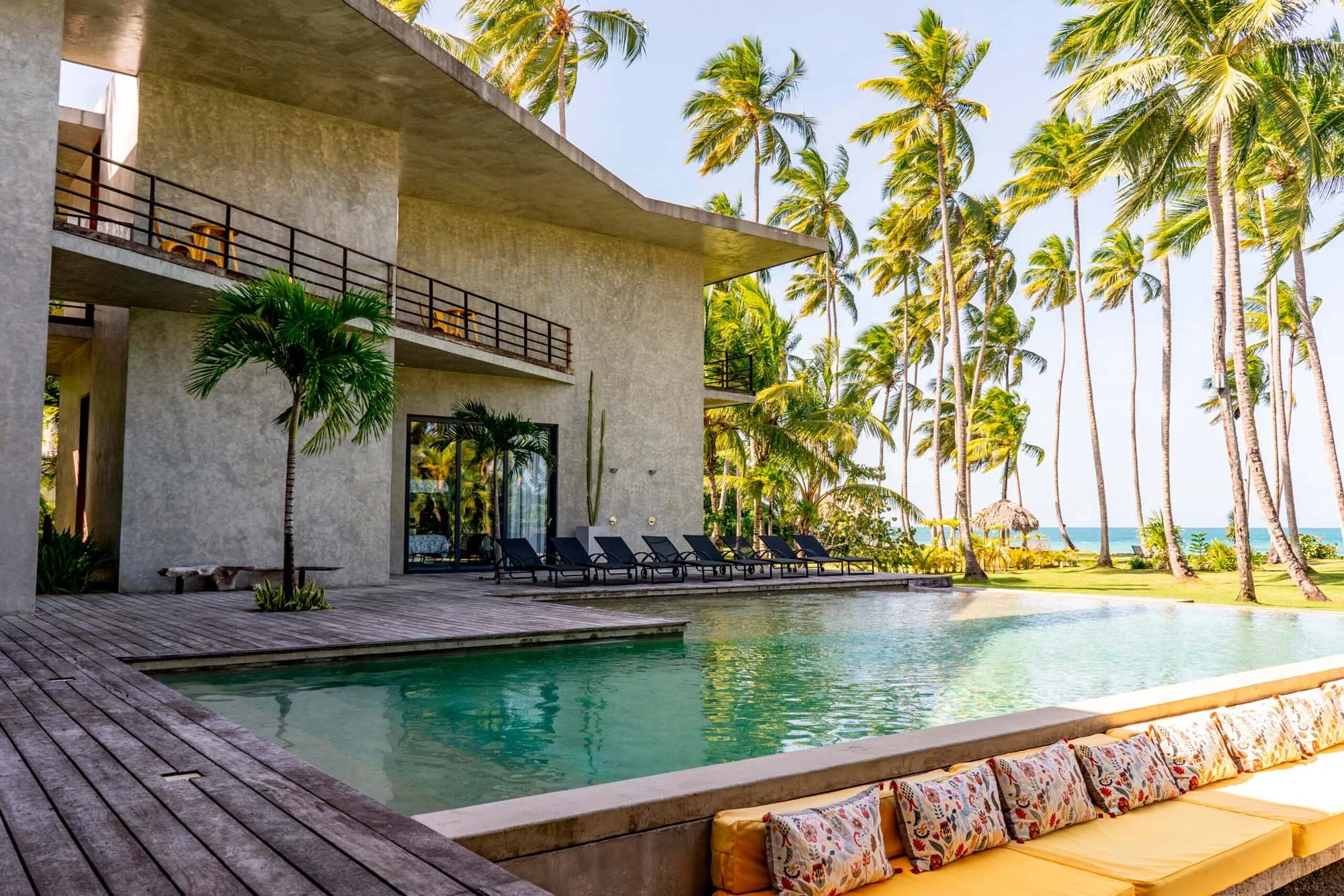 wide landscape photo of the pool and architecture of casa rosabaya in samana