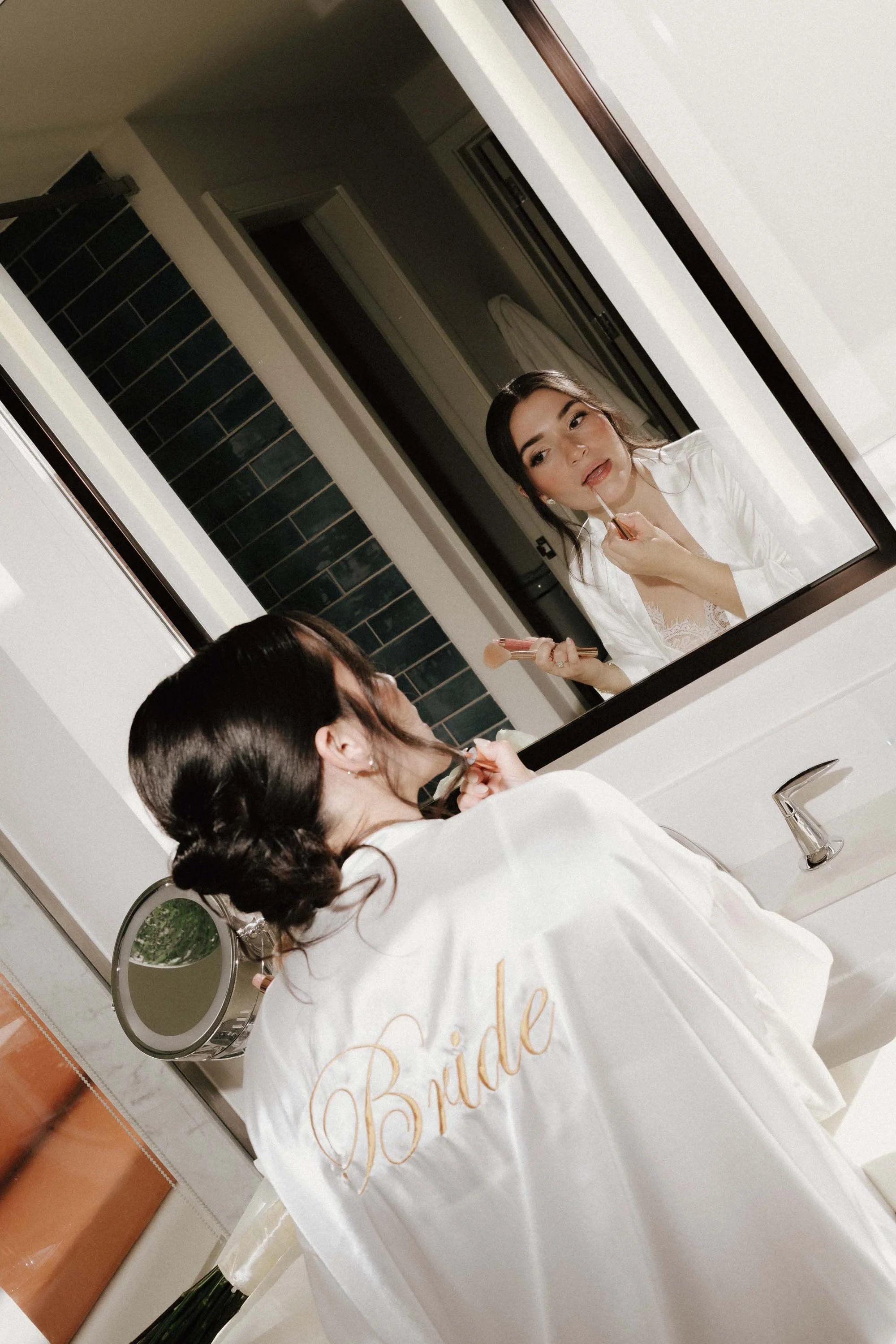 Bride getting ready with her makeup in her room