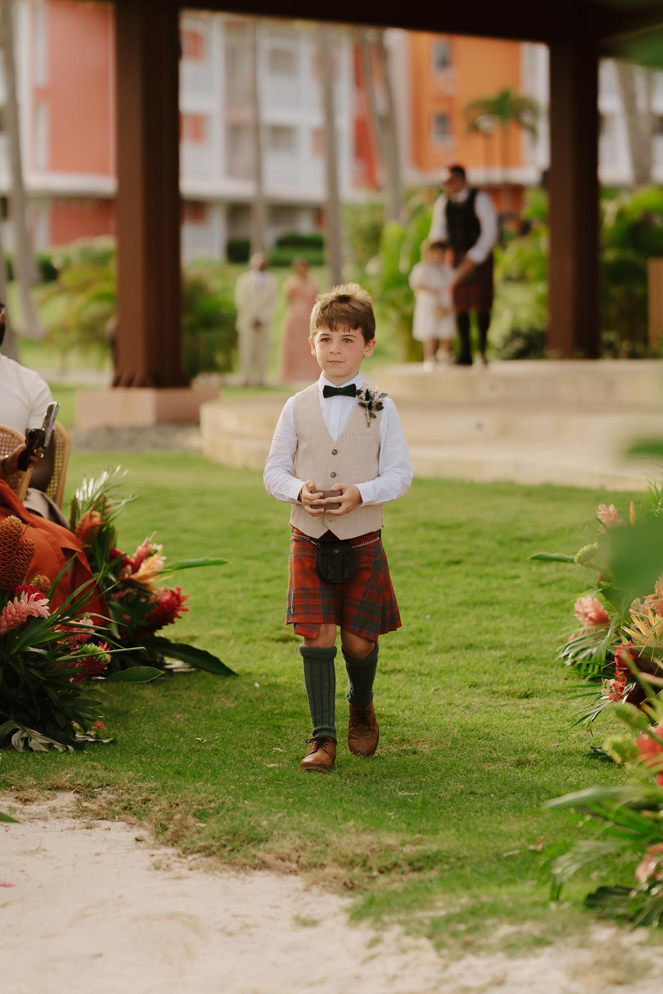 Kid with rings walking down to the aisle in the ceremony wearing a kilts in Chez Bisutti Punta Cana Dominican Republic