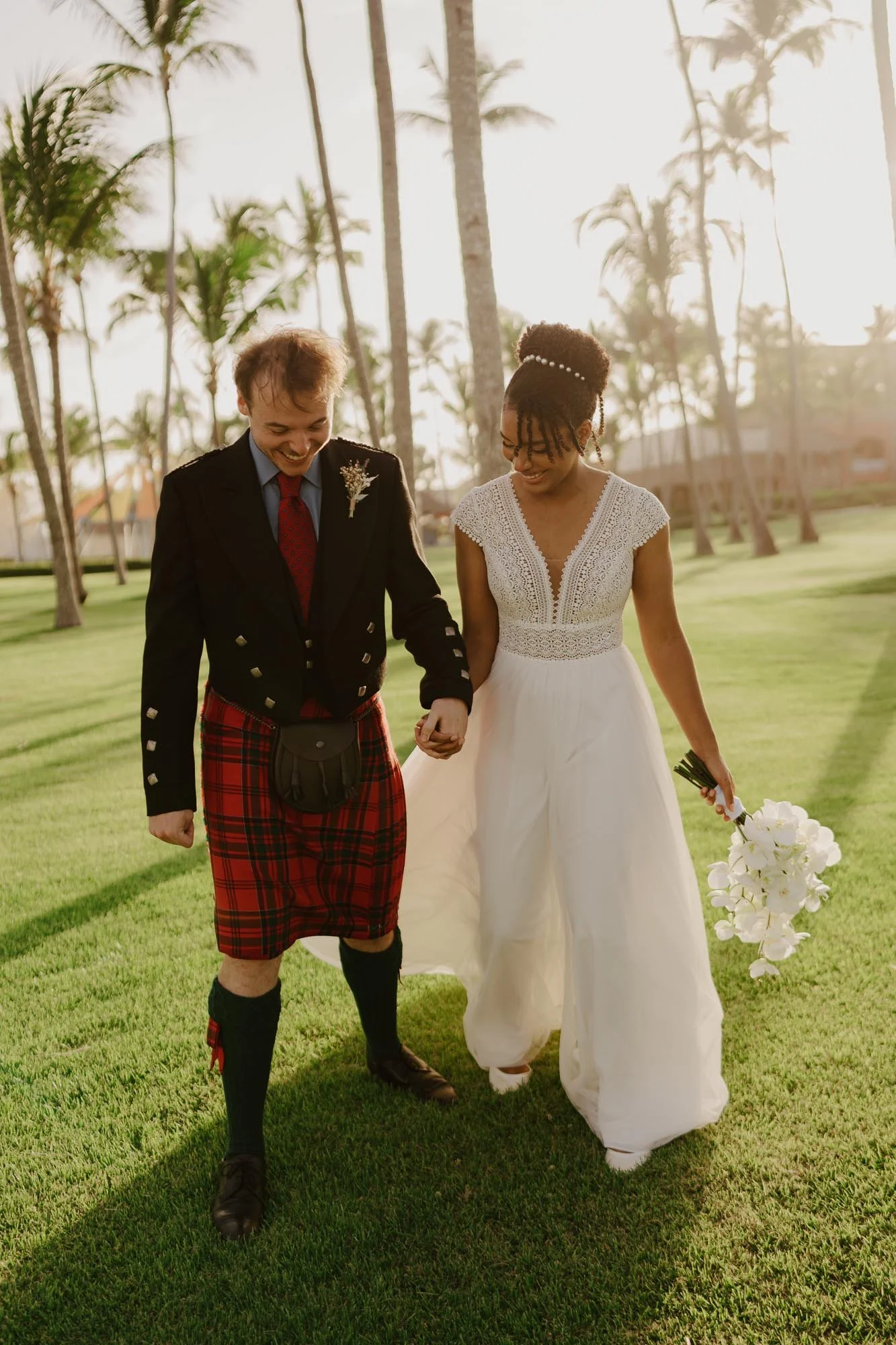 Bride and groom walking down in sunset candid moment wedding photography chez bisutti punta cana