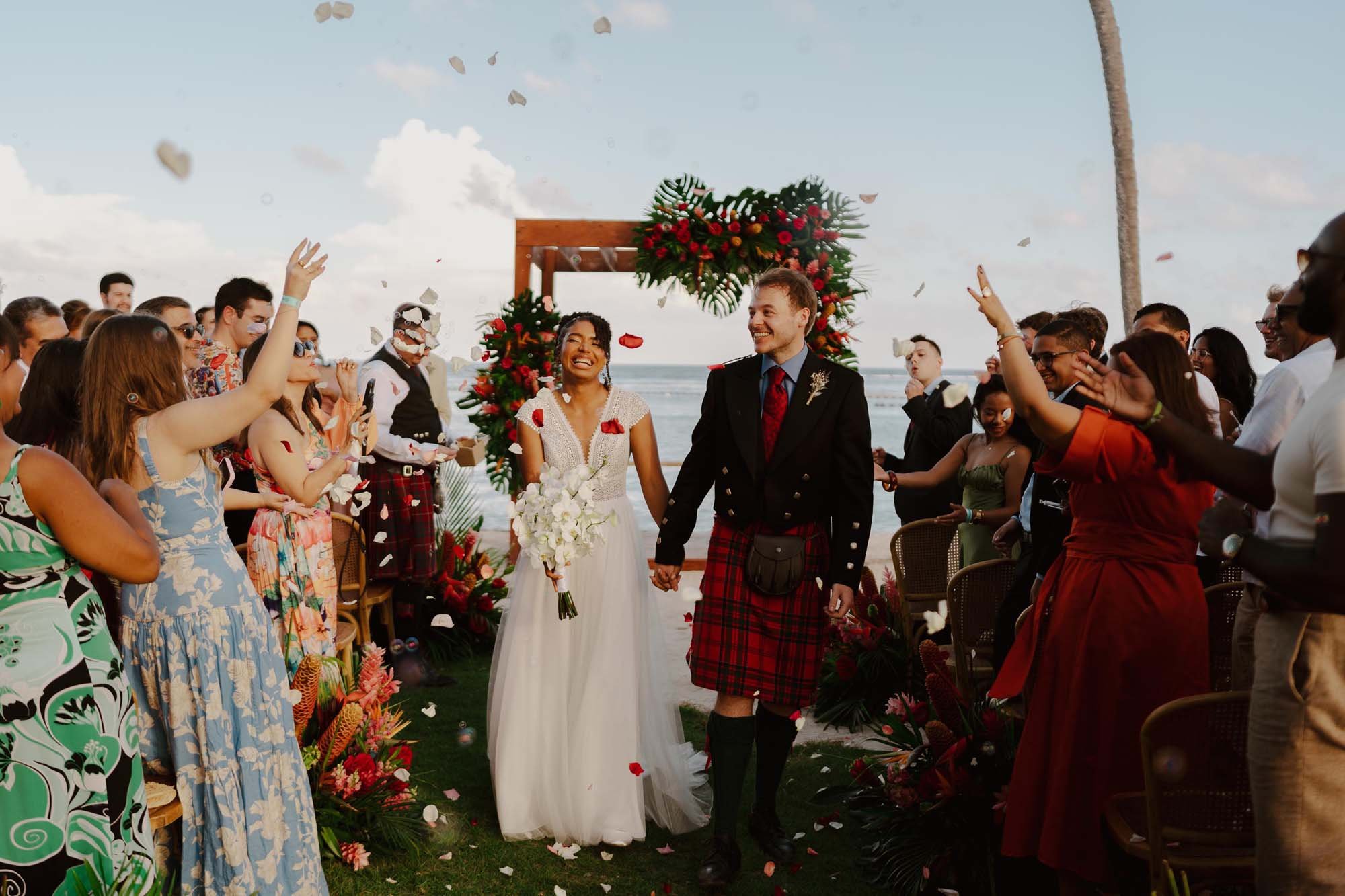 Couple holding hands and walking down the aisle after the first kiss