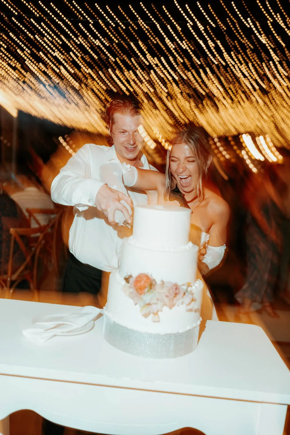 bride and groom cutting the cake