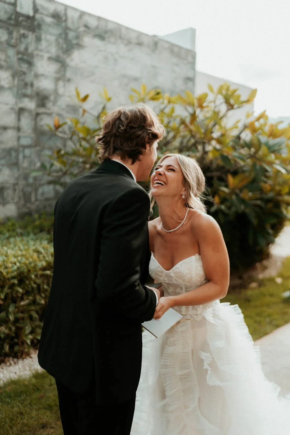 candid moment between bride and groom while reading the vows