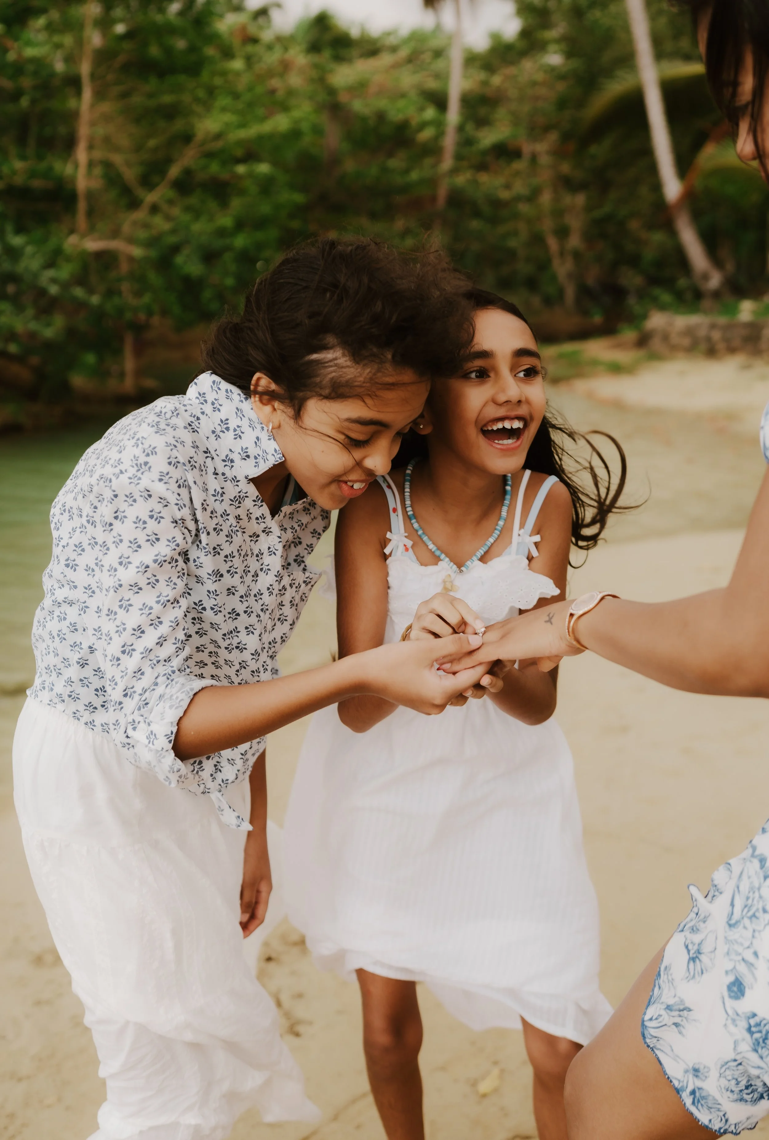 The daughters of the couple watching the engagement ring of their fathers in surprise in a surprise engagement proposal in Samana Dominican Republic