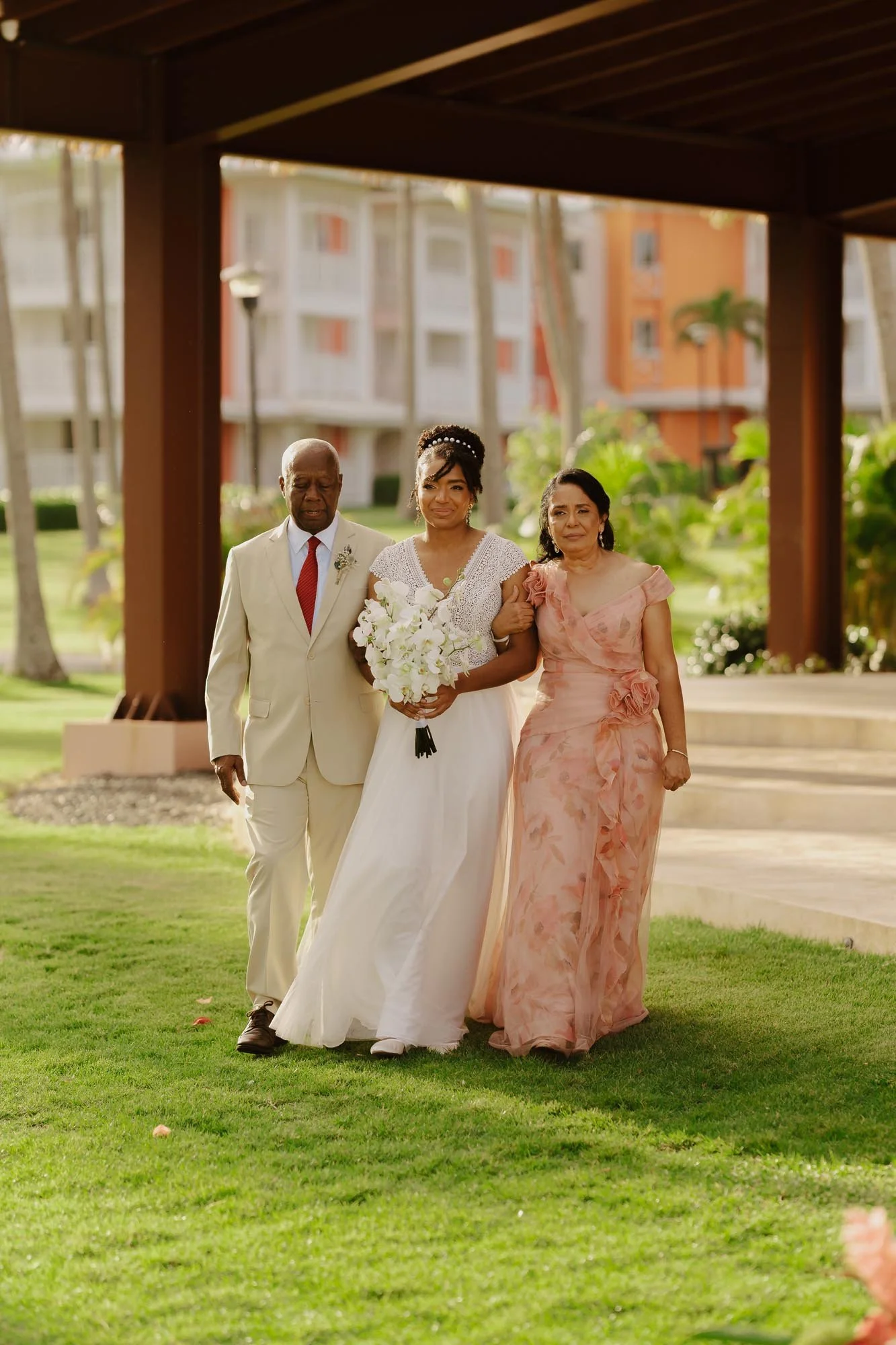 Dominican Bride walking down the aisle with her fathers in Chez Bisutti Punta Cana Dominican Republic