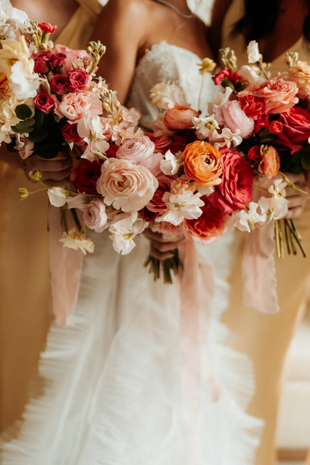 Bride and bridemaids holding down their bouquet for a detail photo