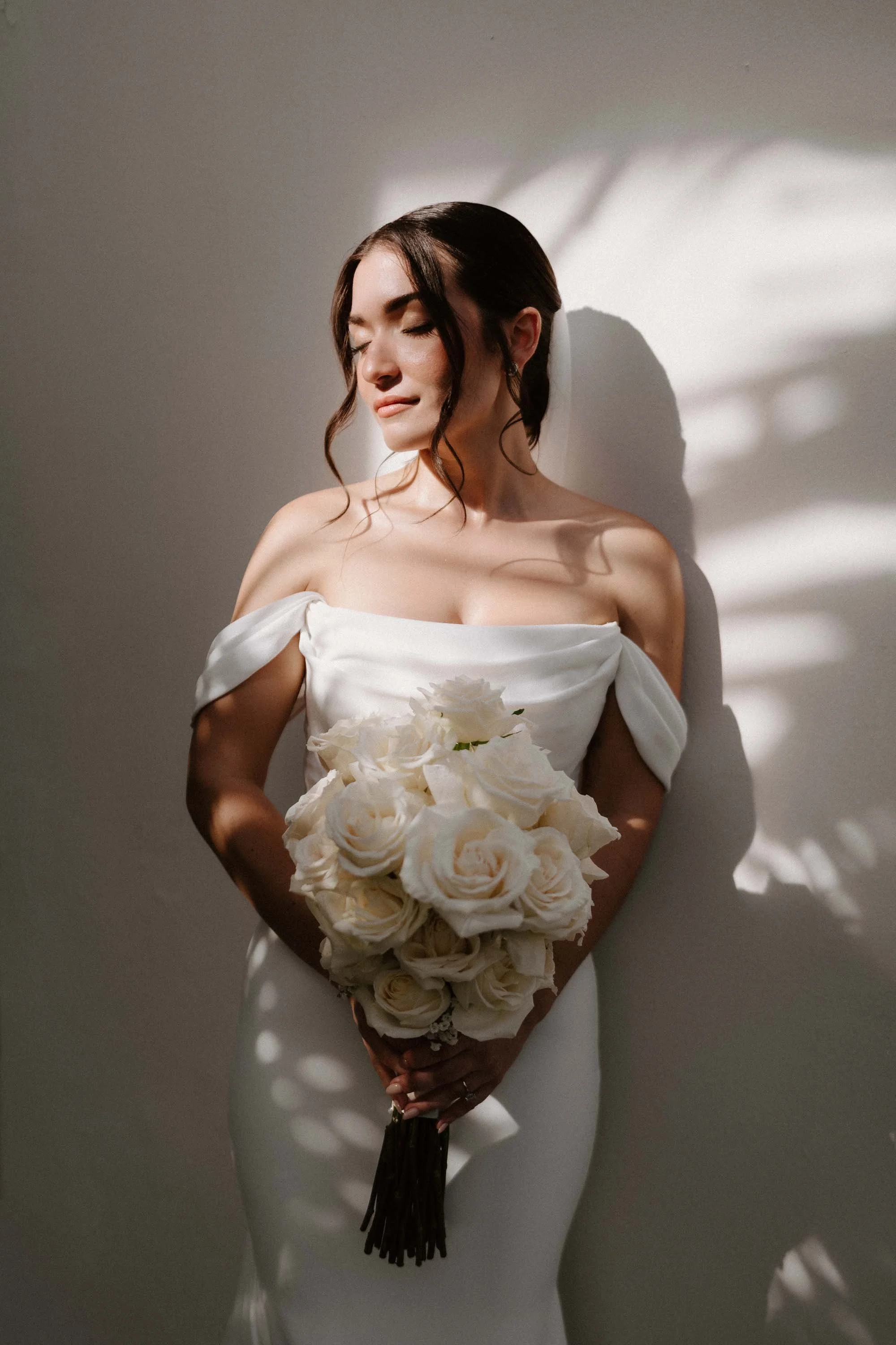 Photo of a bride holding the bouquet and flowers